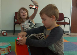 Picture of children playing with toy cars.