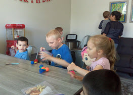 RAD Mother's Day Children playing at table.