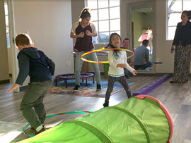 Children playing hula hoop at Milestone Family Solutions