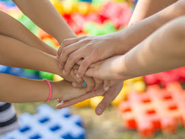 Family's hands joined together.