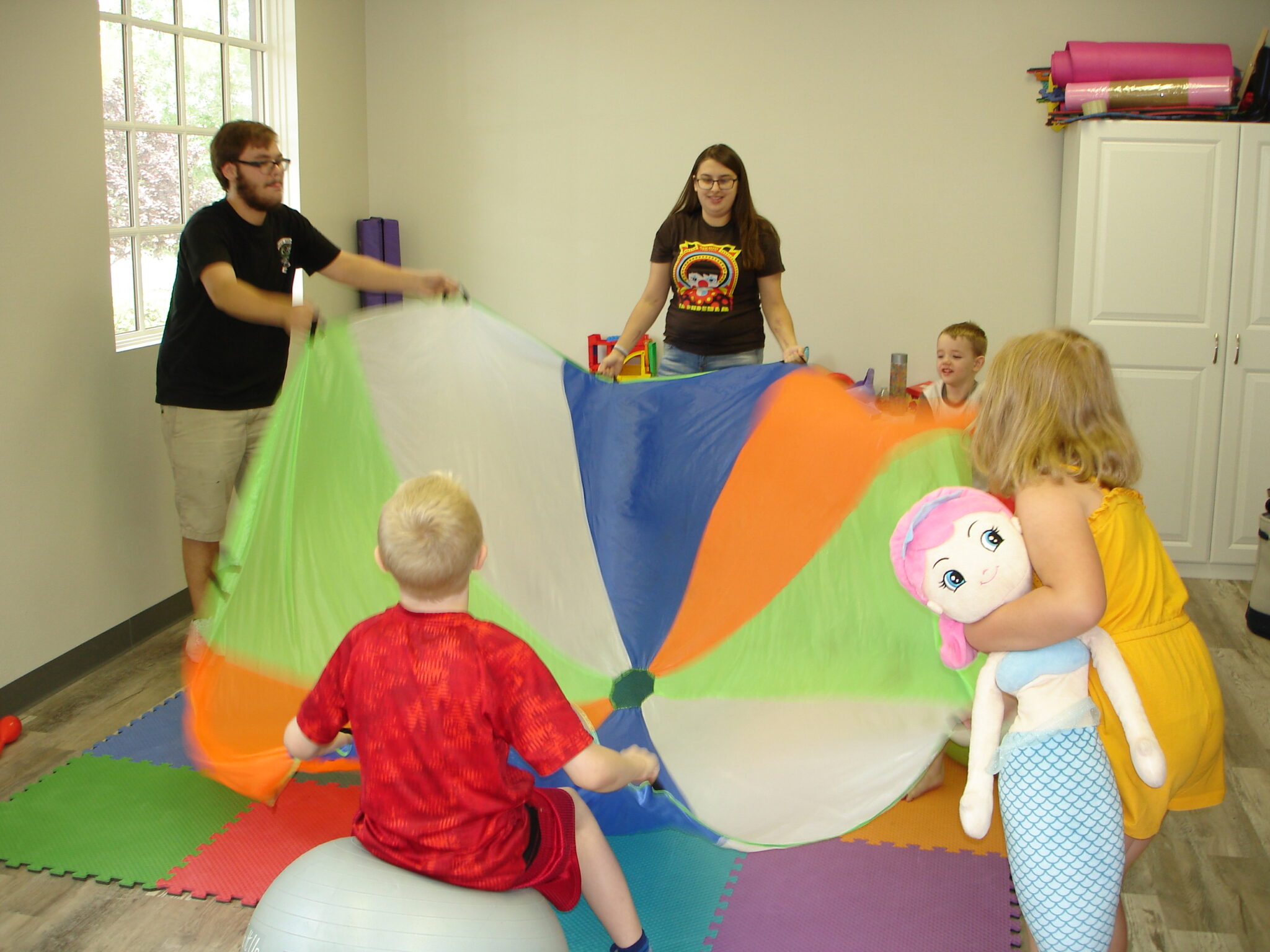 Children playing with parachute