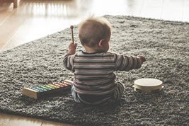 Small child playing music.