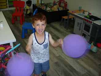 Child with balloons in Imagination Station